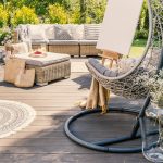 Inviting patio area features a comfortable lounge setup, complete with an easel for creative pursuits- perfect example of an outdoor living space in Roanoke.