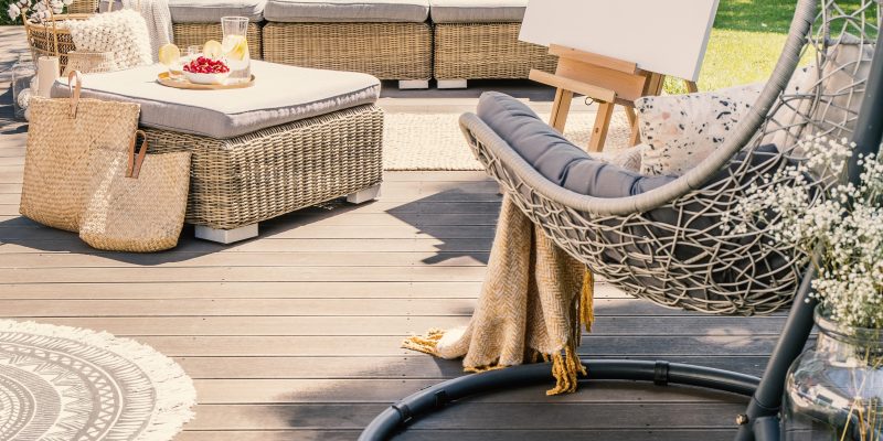 Inviting patio area features a comfortable lounge setup, complete with an easel for creative pursuits- perfect example of an outdoor living space in Roanoke.