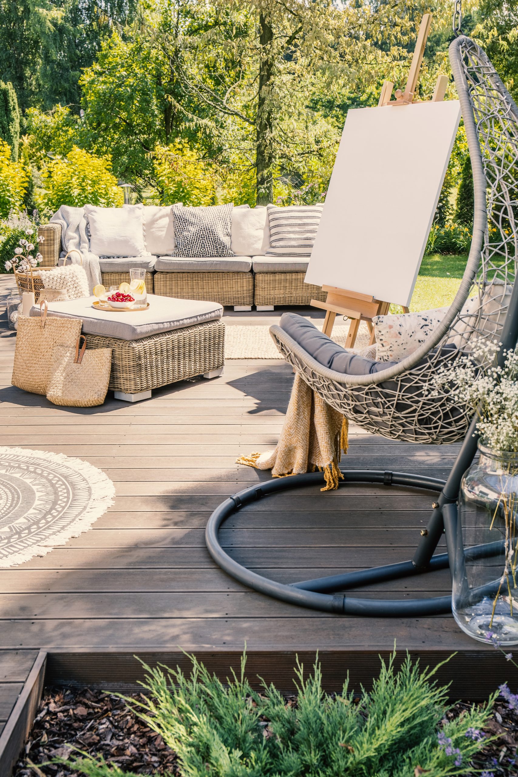 Inviting patio area features a comfortable lounge setup, complete with an easel for creative pursuits- perfect example of an outdoor living space in Roanoke.