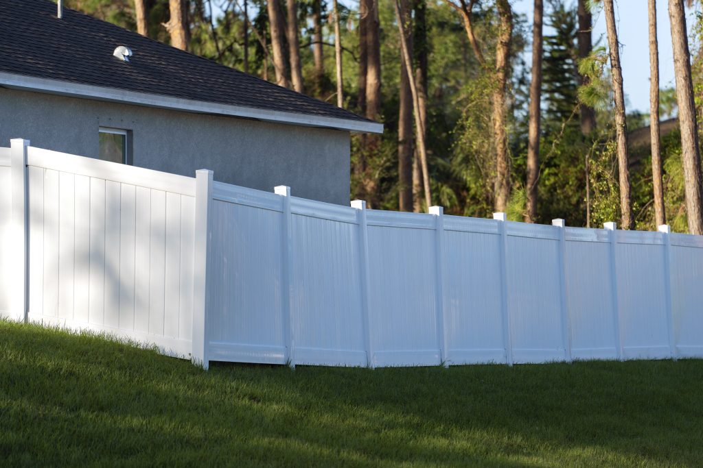 final product of vinyl fence installation on lawn 